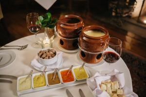 a table with two glasses of wine and a tray of food at Casa Grande Hotel Resort & Spa in Guarujá