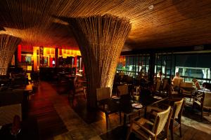 a restaurant with tables and chairs in a room at Casa Grande Hotel Resort & Spa in Guarujá +84 photos