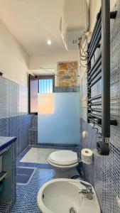 a bathroom with a toilet and a sink at Appartamento Cinisi in Cinisi