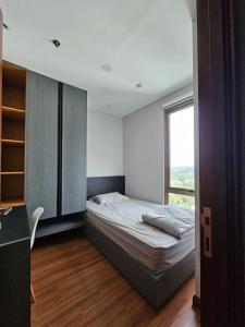 a bedroom with a bed and a window at Hegarmanah Residence Apartment in Bandung +11 photos