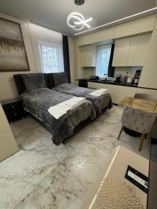 a bedroom with a large bed and a kitchen at Luxurious House with Deluxe rooms & Free Secured Parking in Sofia