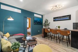 a living room with a couch and a table at Prime Old City Condo Free Parking Skyline Views in Philadelphia