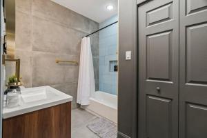 a bathroom with a sink and a shower and a door at Prime Old City Condo Free Parking Skyline Views in Philadelphia +40 photos