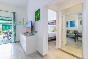 a bedroom with a bed and a living room at Campo Golf 14 by VillaGranCanaria in Maspalomas +47 photos