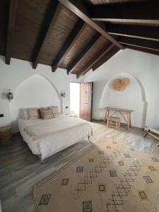 a bedroom with a large bed and a wooden floor at La Casa De Mama in Marbella