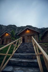 a stairway leading up to a wooden cabin with a building at Azure Lagoon Resort 