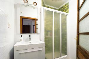 a bathroom with a sink and a shower at Little Yellow House in Gijón +23 photos
