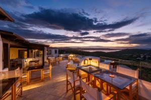 a view from the balcony of a house with tables and chairs at Hotel Pedra Santa in Baja Sardinia