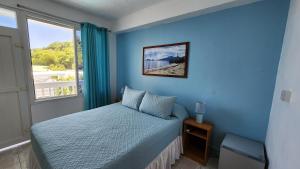 Ένα ή περισσότερα κρεβάτια σε δωμάτιο στο OEManagement Rooms