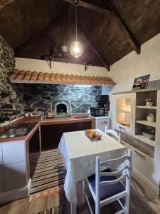a kitchen with a table with a bowl of fruit on it at Casa Rosa in Camacha