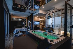a room with a large tub in the middle of a bedroom at 2401 at Mercury by AURA in St. Julianʼs