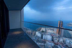 a view of the ocean from a building balcony at 2401 at Mercury by AURA in St. Julianʼs