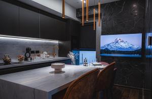 a kitchen with a table with chairs and a tv at 2401 at Mercury by AURA in St. Julianʼs