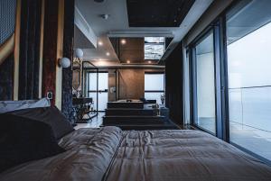 a bedroom with a large bed and a staircase at 2401 at Mercury by AURA in St. Julianʼs