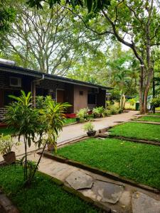 a house with a garden in front of it at Udawalawe Safari Village by Plateeno in Udawalawe