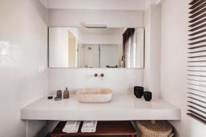 a bathroom with a sink and a mirror at Syrrho's in Vari +12 photos