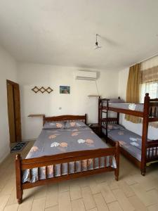 a bedroom with two bunk beds in a room at Villa Gjoka in Velipojë
