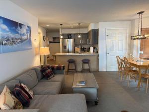 a living room and kitchen with a couch and a table at Pico F101 in Killington