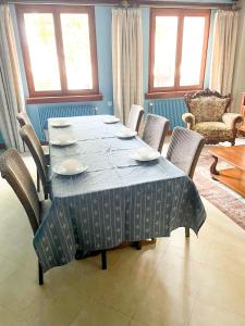 a dining room table with chairs and a blue table cloth at Central & quiet, Full apt for 8 Trésor caché in Colmar +5 photos