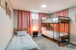 a bedroom with two bunk beds and a window at Lovely family home in Northglenn with fenced yard and bonus room in Northglenn