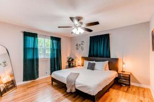 a bedroom with a bed and a ceiling fan at Lovely family home in Northglenn with fenced yard and bonus room in Northglenn