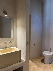 a bathroom with a sink and a toilet at Agatirso in Capo dʼOrlando +16 photos