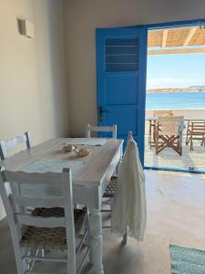 a table with a cat laying on it next to a door at Apleton Beach House Kimolos at Zacharias Beach in Kimolos +62 photos