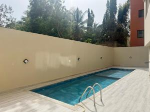 a swimming pool in the side of a house at Beautiful apartment at point E, Dakar in Dakar