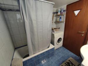 a bathroom with a shower and a washing machine at George's Family house in Larisa +18 photos
