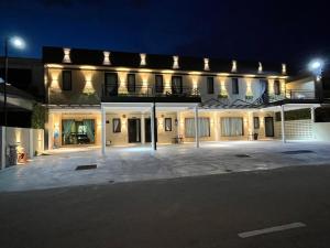 a large building with a parking lot at night at Gold Plus Homestay 5970 in Kuantan +3 photos
