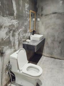 a bathroom with a white toilet and a sink at Gold Plus Homestay 5970 in Kuantan