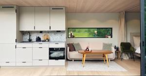 a kitchen with white cabinets and a table in a room at Flåm Retreat in Aurland +22 photos