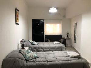 a bedroom with two beds and a couch in it at Moreno924 in Barraquero
