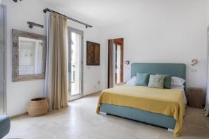 a bedroom with a bed with a yellow and blue blanket at Villa Il Basto 8 by Massimo Villas in SantʼAmbrogio +34 photos