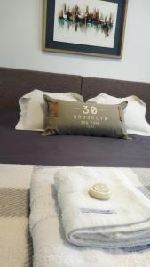 a bed with a blanket and a towel on it at Amado Sur Apartment in San Carlos de Bariloche
