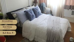 a bed with pillows on it in a bedroom at 4th- Sea View of Seawind Condominium in Davao City