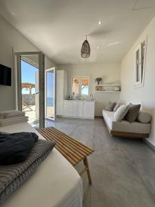 a living room with two beds and a kitchen at Achinos Kimolos Studios in Kimolos