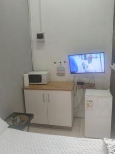 a bedroom with a bed and a television on a counter at Melee's house in Richards Bay