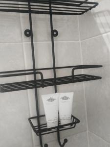 a shelf in a bathroom with two cups on it at Melee's house in Richards Bay