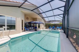 an indoor swimming pool with a glass ceiling at Tuscan Pines Villa in Davenport