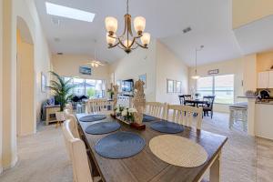 a dining room and living room with a table and chairs at Tuscan Pines Villa in Davenport