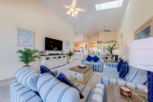 a living room with blue couches and a tv at Tuscan Pines Villa in Davenport