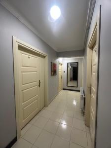 a hallway with a door and a tile floor at Gözde Hotel Tekirdağ in Tekirdag +70 photos