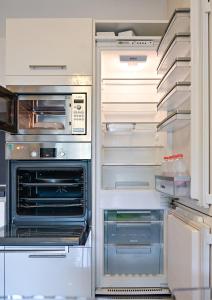 an open refrigerator with its door open with its doorsktopktop at Luxurious Lugano Apartment with City Views in Lugano