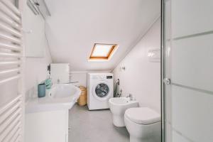 a bathroom with a toilet sink and a washing machine at Terrazza d'Amare - Alassio Centro in Alassio +22 photos