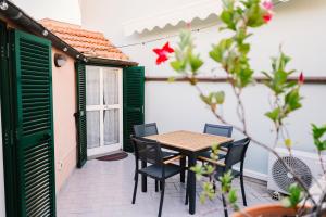 a table and chairs on the patio of a house at Terrazza d'Amare - Alassio Centro in Alassio