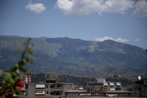 a view of a city with mountains in the background at Doel's Villa in Gjirokastër