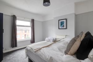 a bedroom with a large bed with a window at Bentley Terrace by YourStays, perfect for Bentley Motors! in Church Coppenhall
