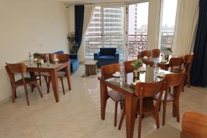 a dining room with tables and chairs with a view at Town Hotel Cairo in Cairo