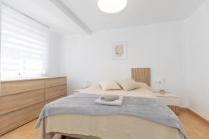 En eller flere senge i et værelse på Bonito Apartamento Paterna 2 Dormitorios